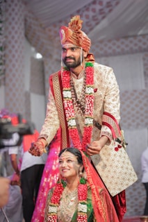 The groom tying the thaali around the bride's neck, symbolizing their sacred union.