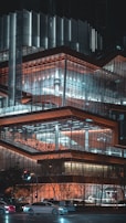 Night view of a commercial property with illuminated glass facades and sleek modern design.