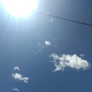 A smooth fiber optic cable stretched across an open landscape under a blue sky.