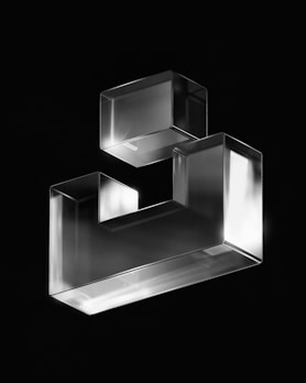 A sleek metal geometric wall sculpture with clean lines and a modern finish.