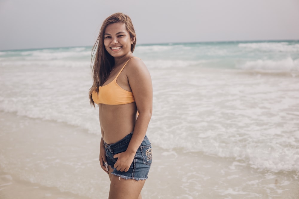 a woman standing on a beach