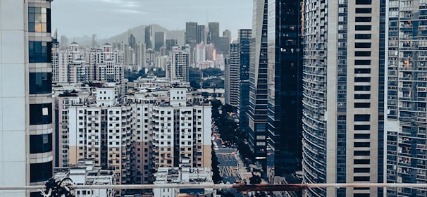 A detailed view of a bustling cityscape with players interacting and upgrading buildings.