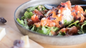 Close-up of a colorful, fresh salad bowl with leafy greens and bright veggies.