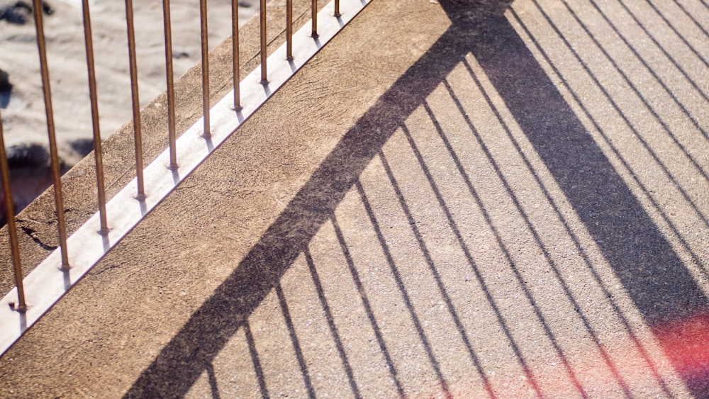 a shadow of a person on a bridge