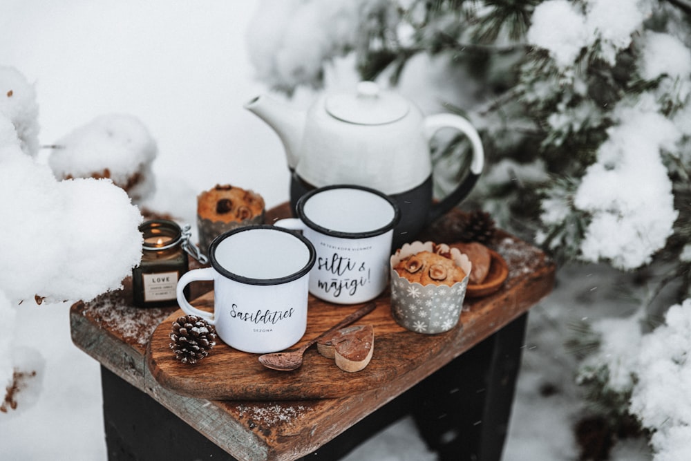 a table with teapots and coffee cups on it