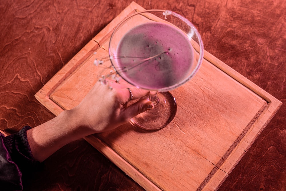 a hand holding a glass of water