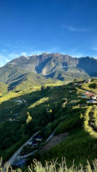 a road going through a valley with mountains in the background