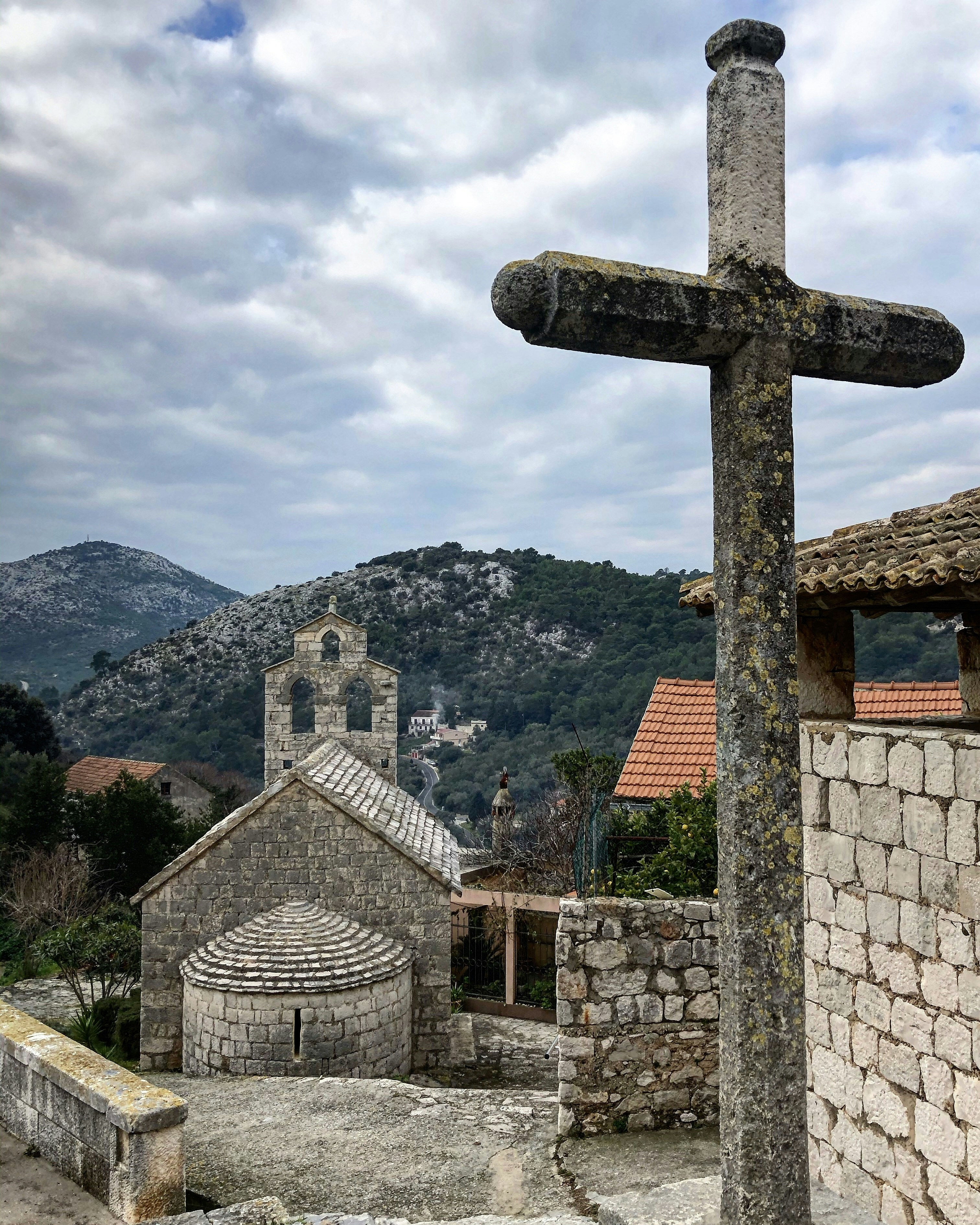 a cross in front of a building