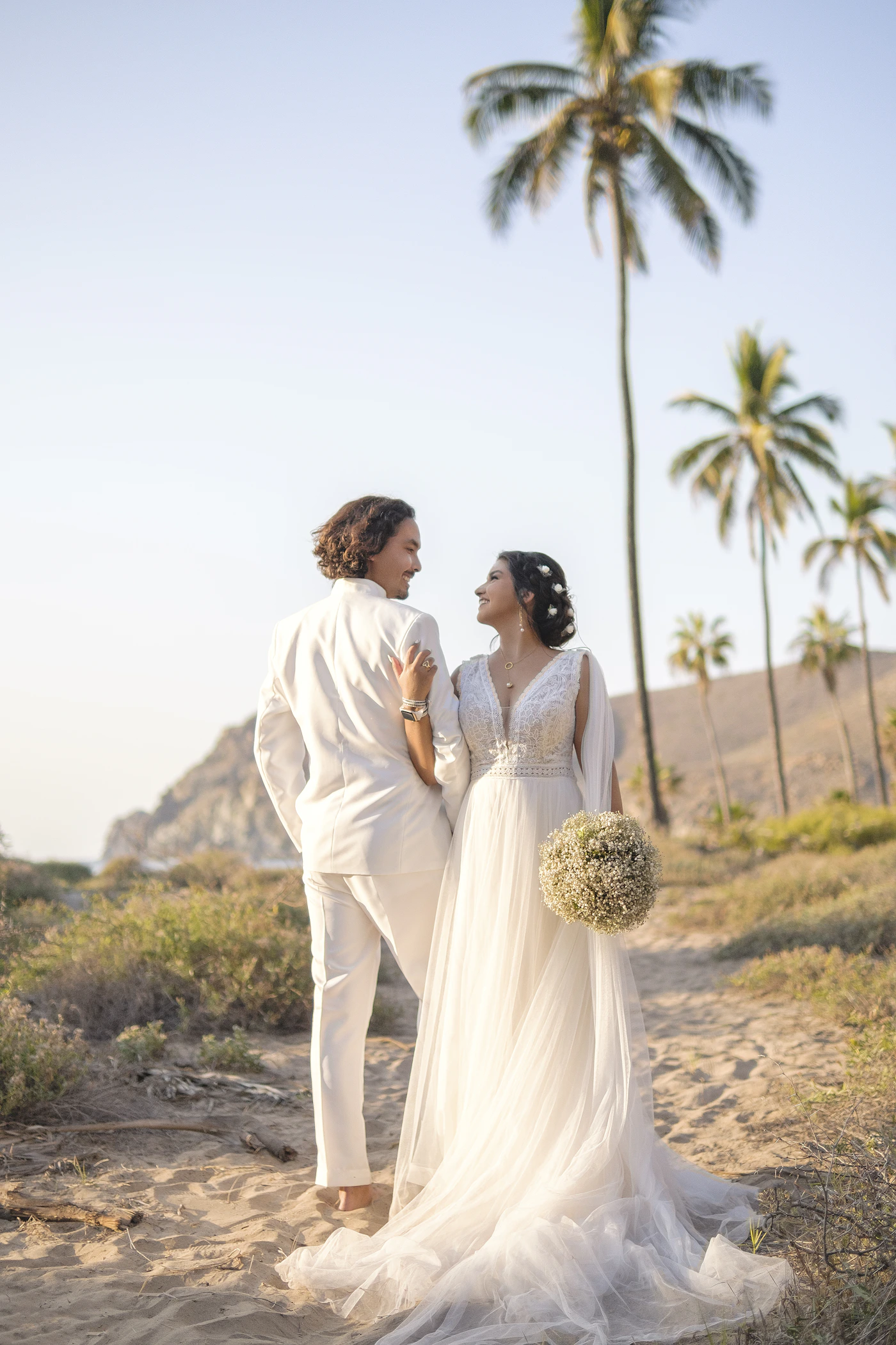 Bride and groom in wedding attire together in a Mexican town
