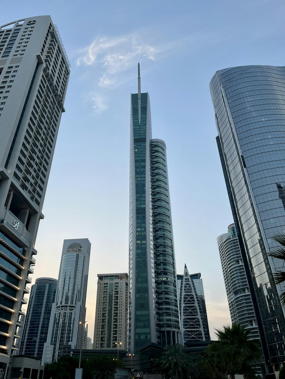 a group of tall buildings with Almas Tower in the background