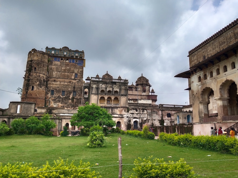 a large stone building with a green lawn in front of it