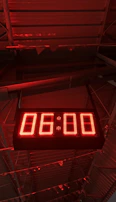 A modern digital clock with large red numbers glowing softly in a dim bedroom.
