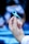 A hand delicately holding a blue awareness ribbon with the background softly blurred to focus on the ribbon.