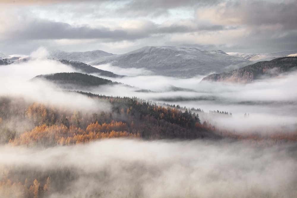 a view of a mountain range and clouds from above