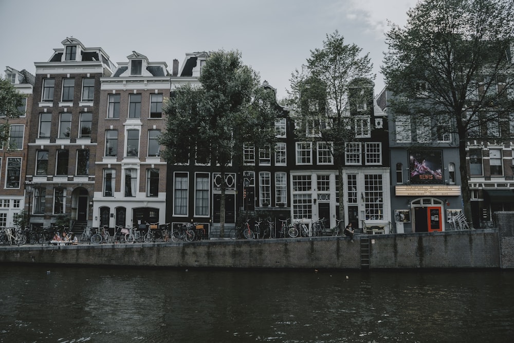 a row of buildings next to a body of water with Anne Frank House in the background