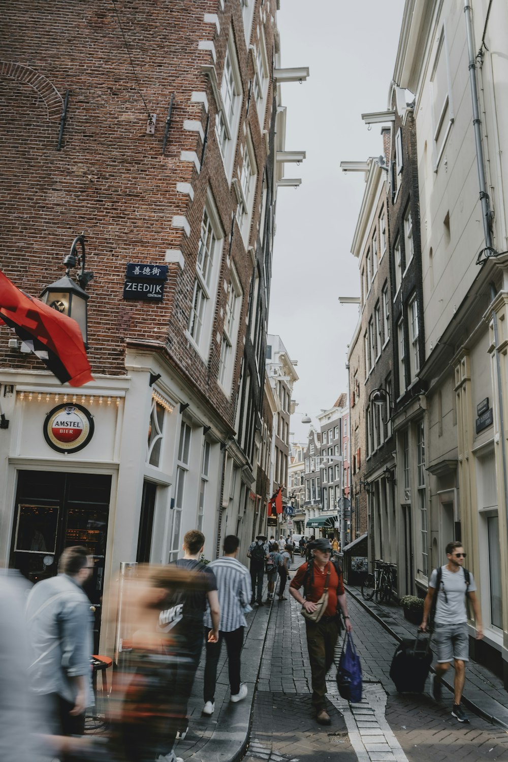 people walking on a sidewalk