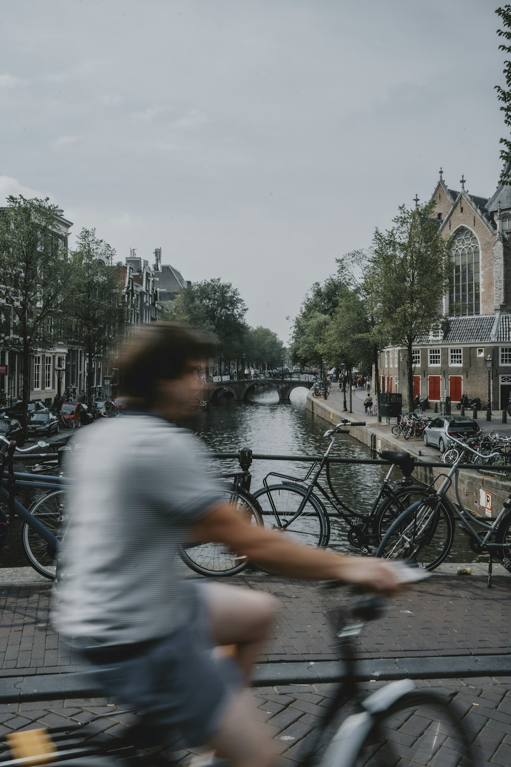 a person riding a bicycle on a street with other bikes