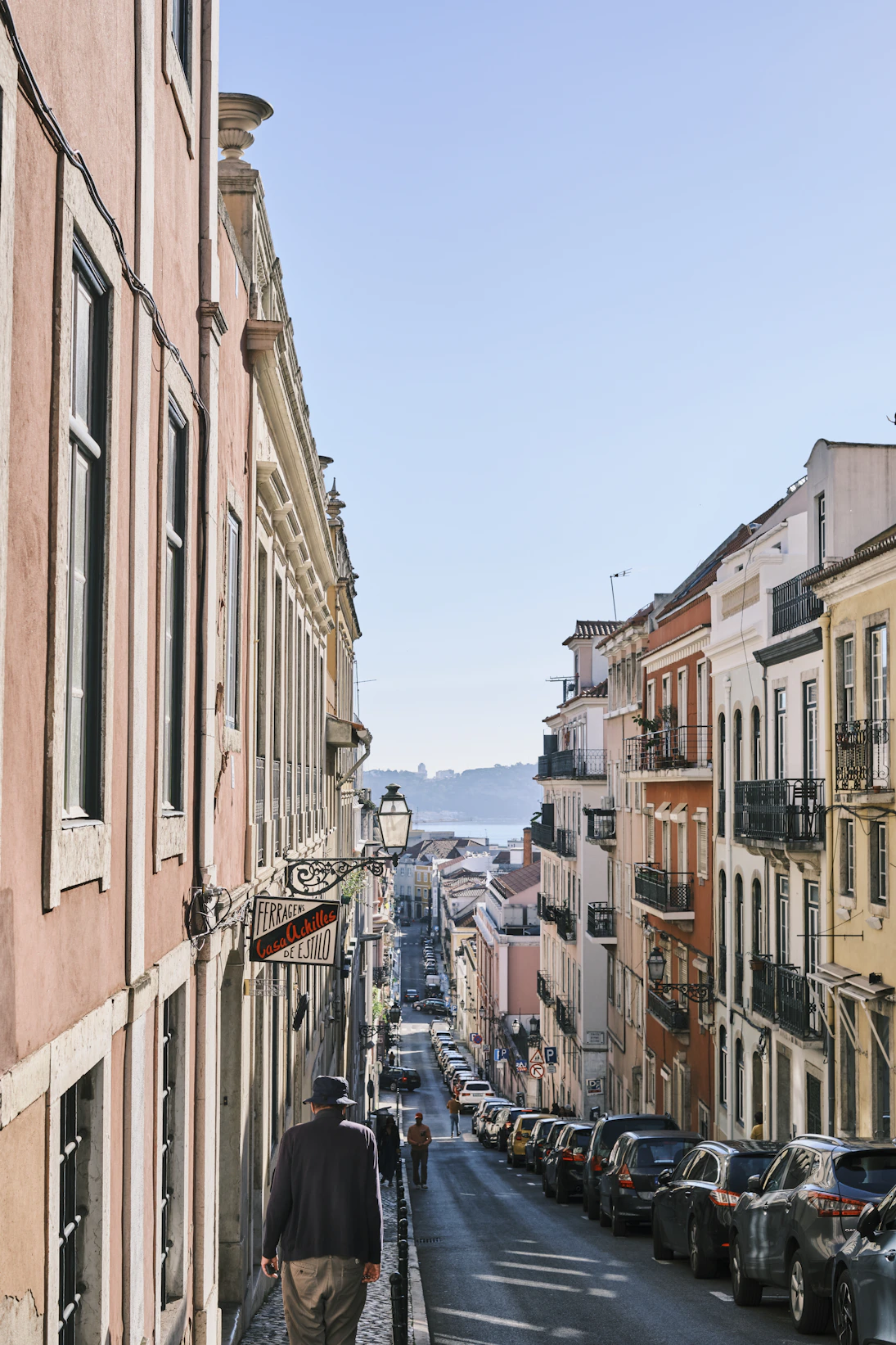 a person walking down a street lined with buildings