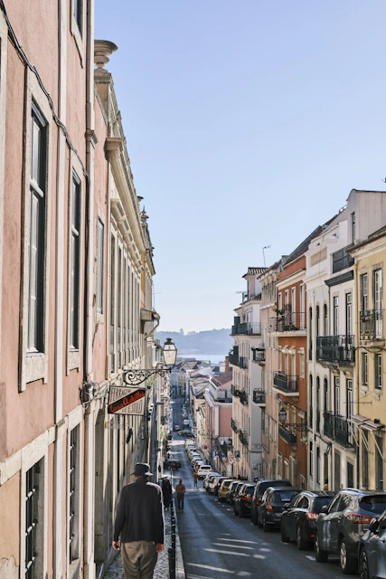 a person walking down a street lined with buildings