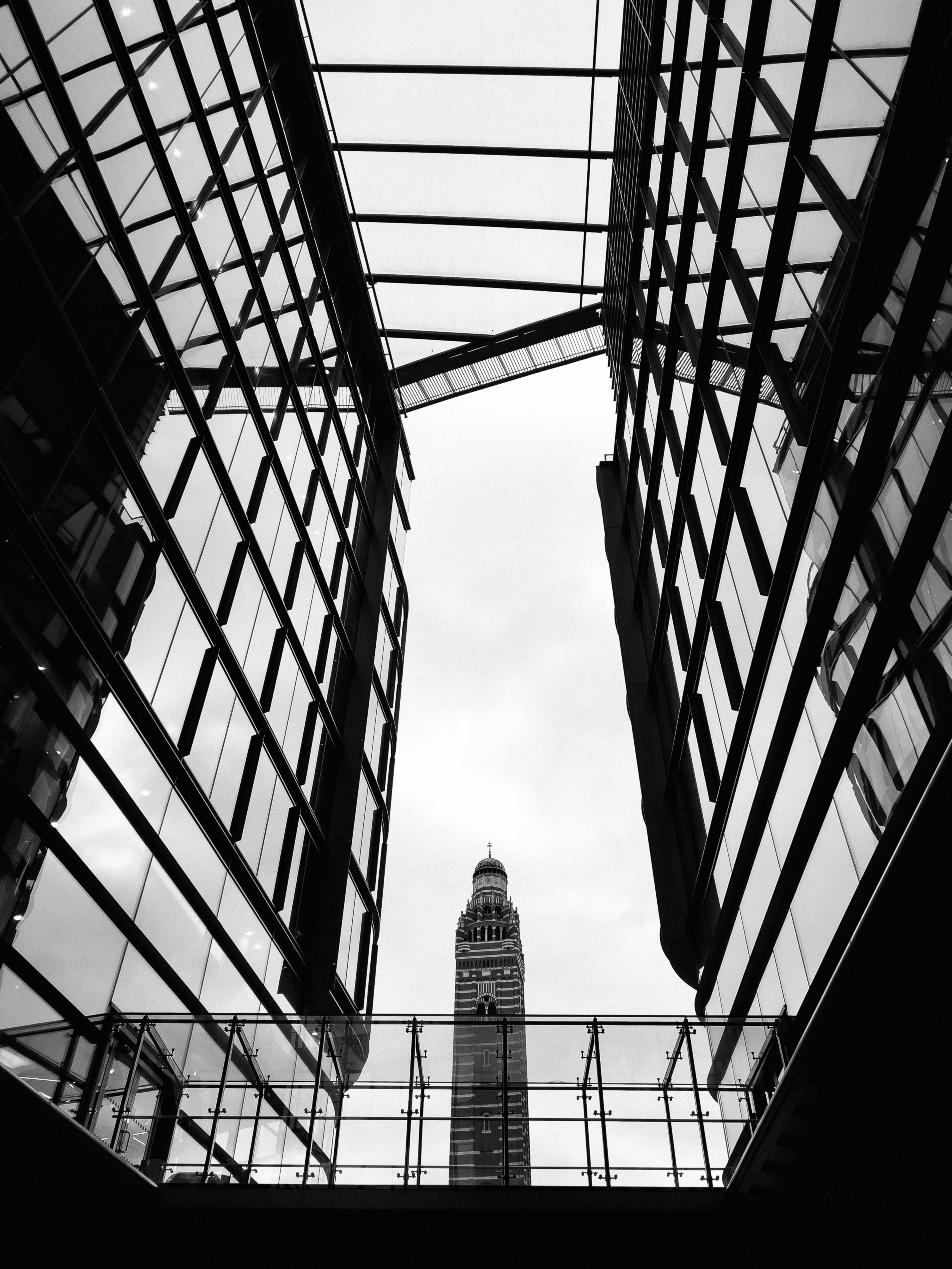 a view looking up at a tall building through a glass window