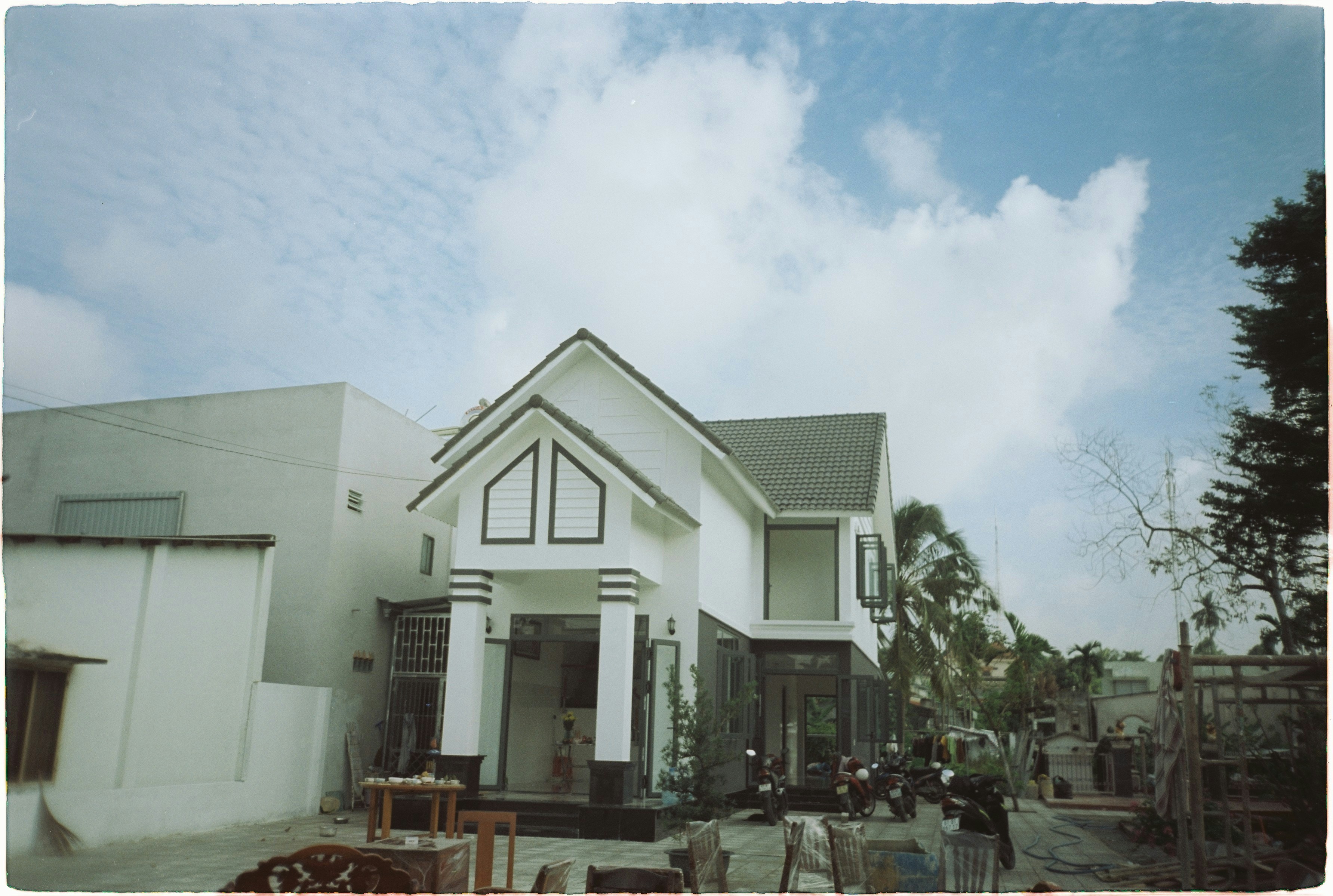 a group of buildings with tables and chairs outside