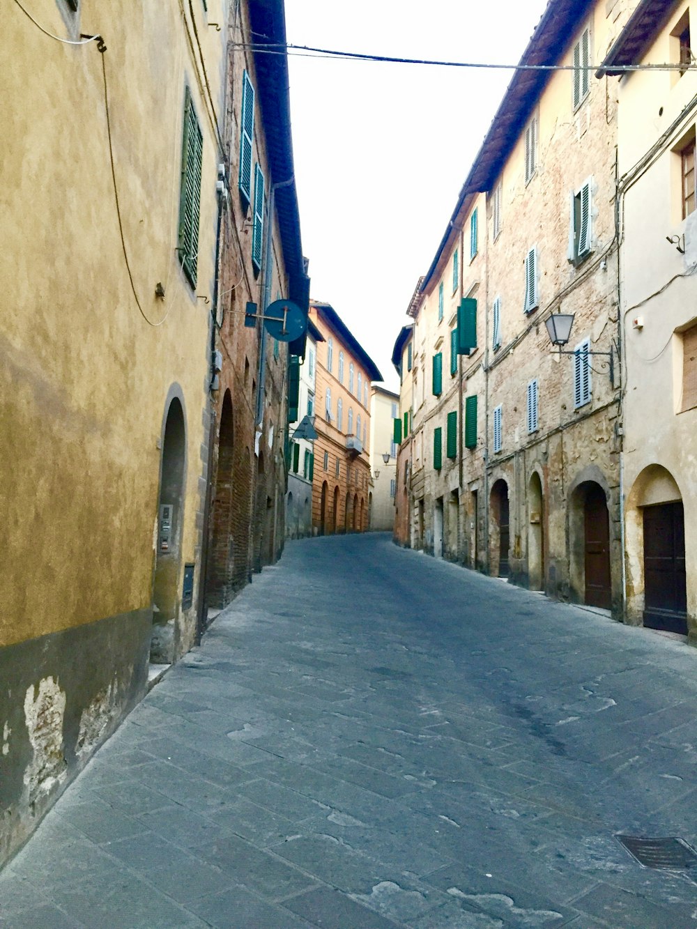 a cobblestone street between buildings