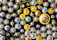 An organized display of various car batteries on shelves.