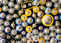 An array of lead acid batteries displayed on a wooden shelf, highlighting different sizes and types available.