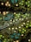 An intricate pattern with abstract floral motifs and circular shapes in neon colors. The design features yellow, turquoise, and white dots on a dark background, creating a visually striking contrast.