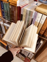 A close-up of hands holding colorful educational materials and books.