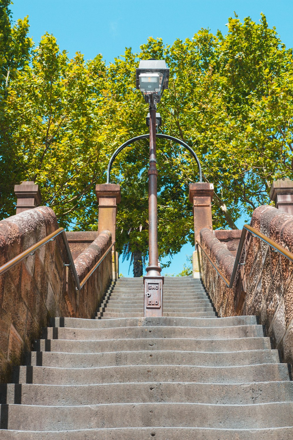 a light post on a stone staircase