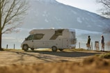 A scenic overlook with an RV parked and a couple enjoying the view.