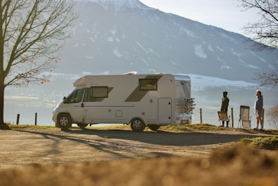 A scenic overlook with an RV parked and a couple enjoying the view.