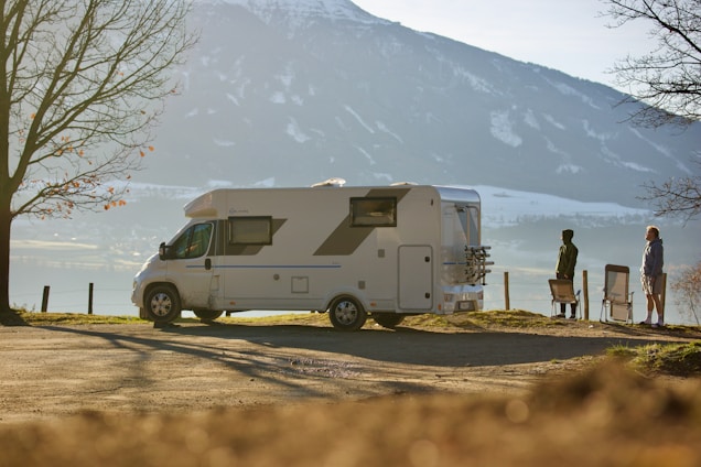 A couple enjoying a scenic view from their camper van.
