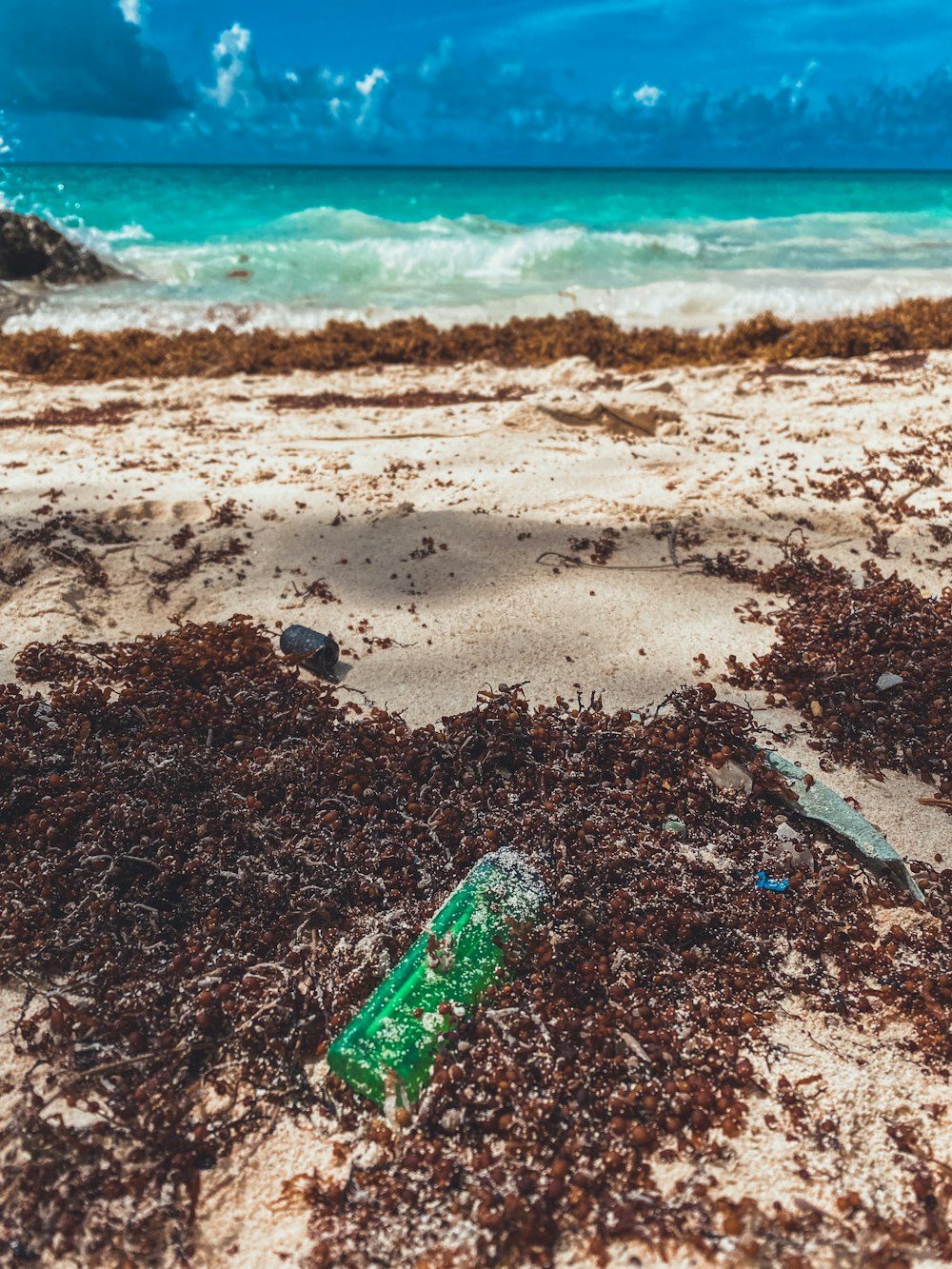 a beach with a blue umbrella