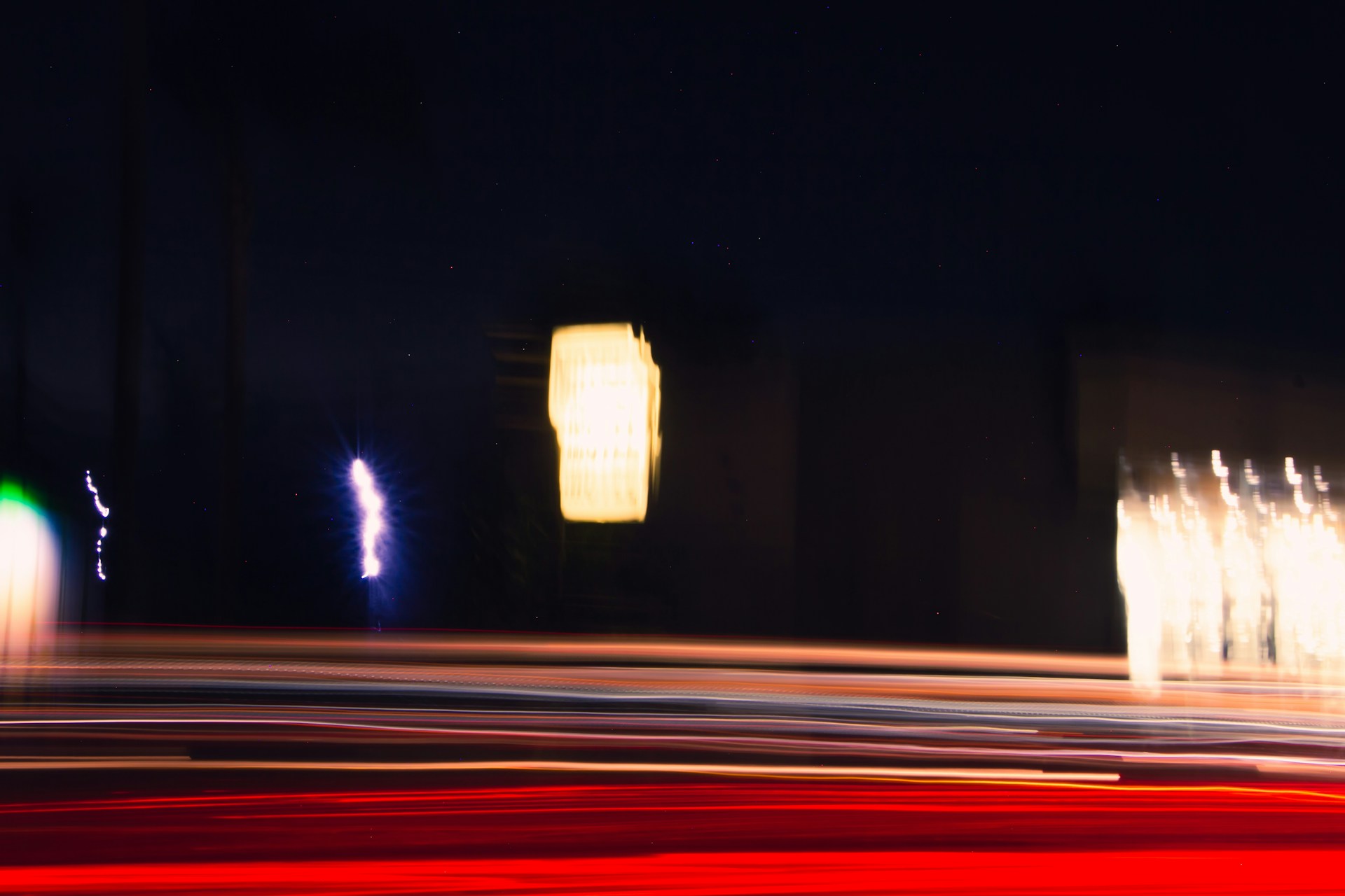 Dynamic frame from a video featuring urban night scenes with stark black and white contrasts, capturing motion and light.