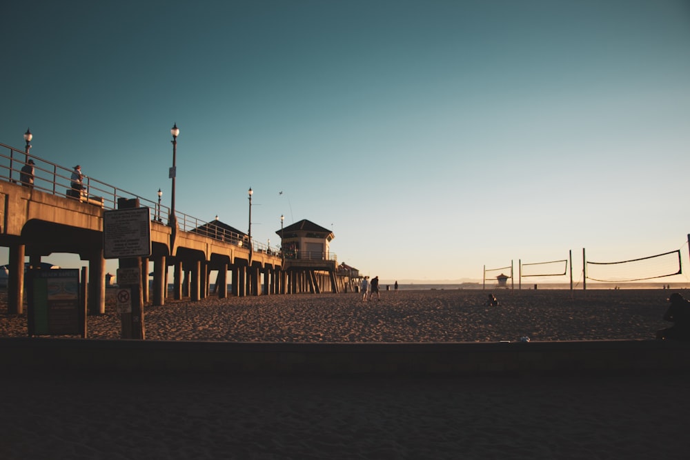 a beach with a pier and a building