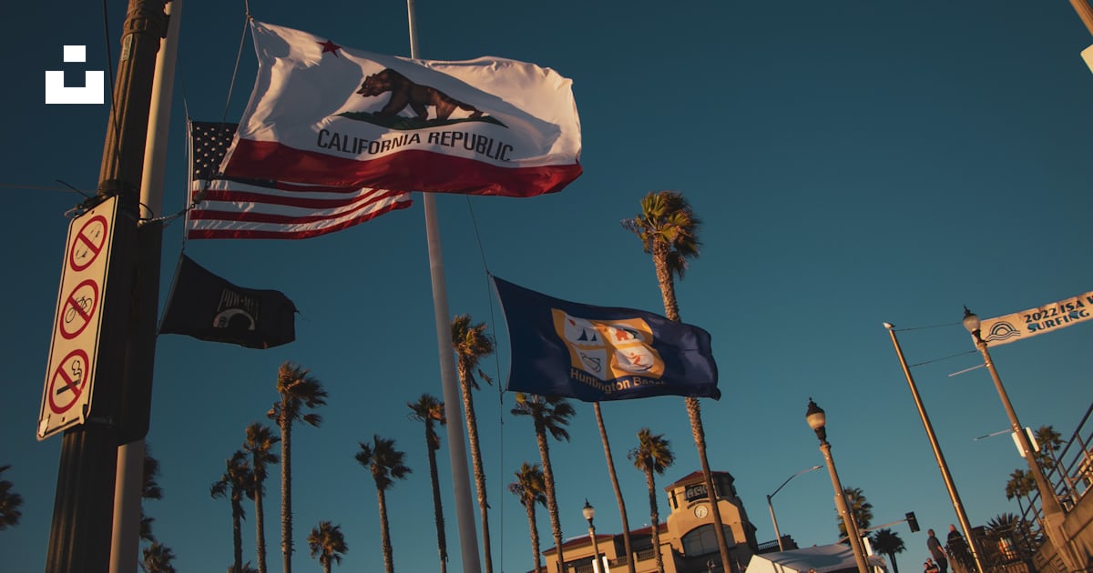 Flags flying in the air photo – Free Huntington beach Image on Unsplash