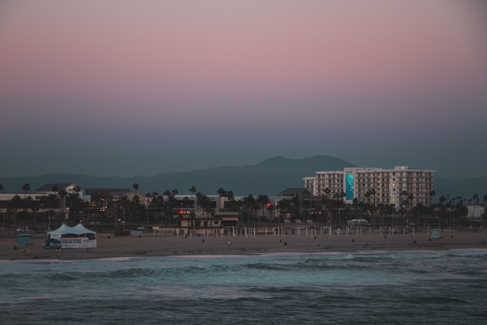 a beach with buildings and water