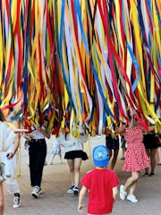 a group of people in a room with a large colorful wall