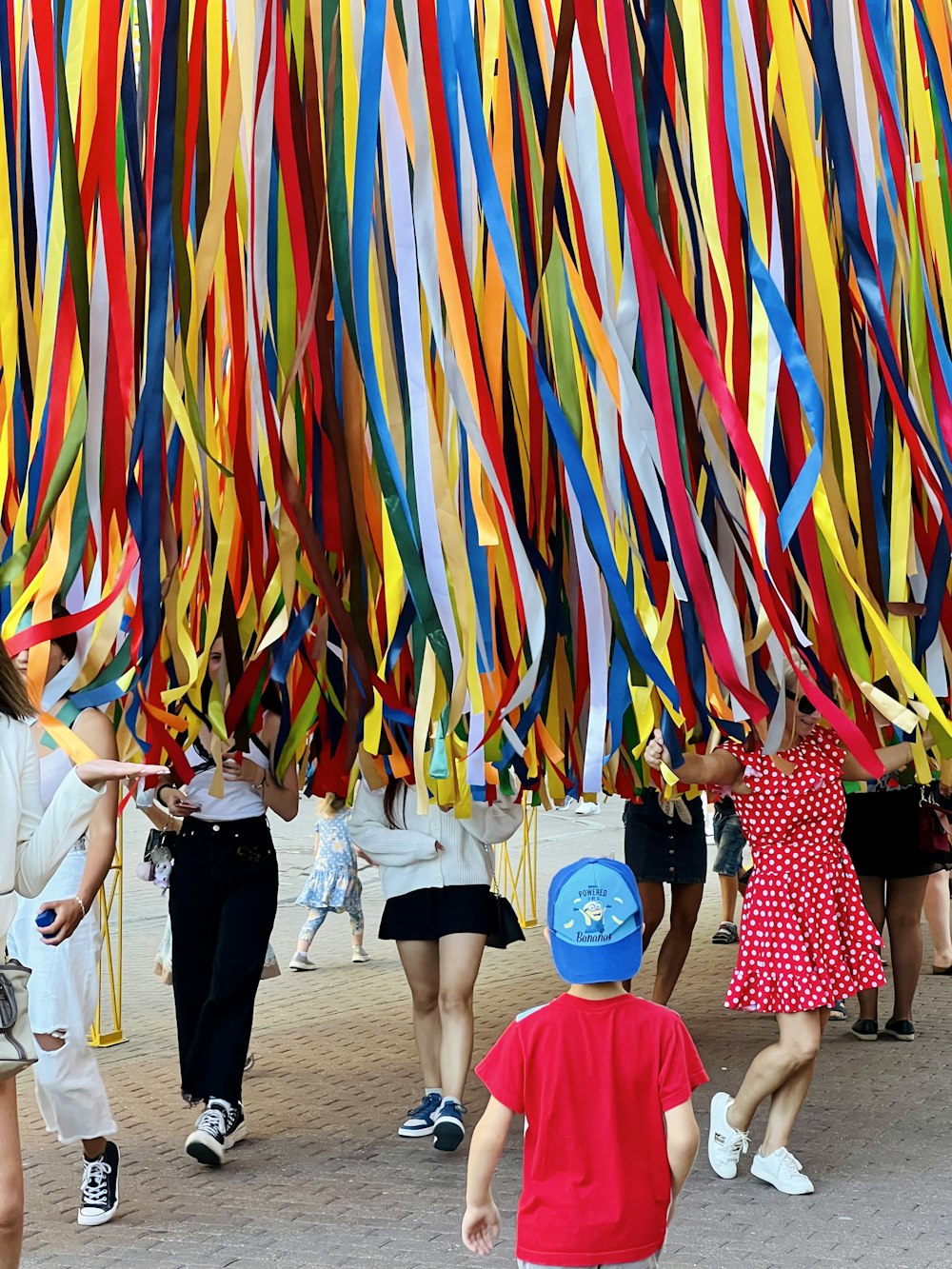 a group of people in a room with a large colorful wall