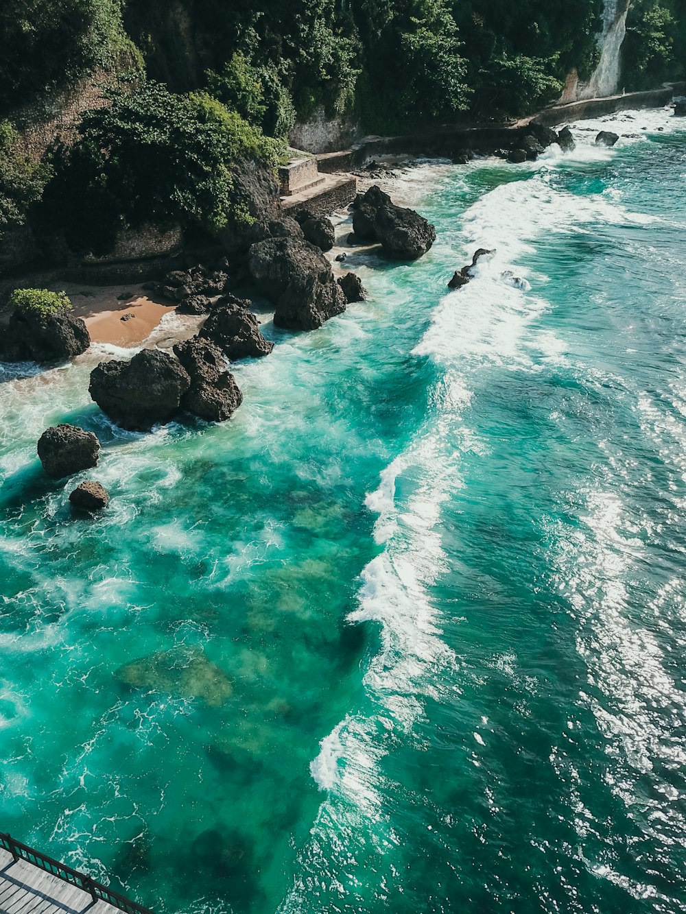 a body of water with rocks and trees around it