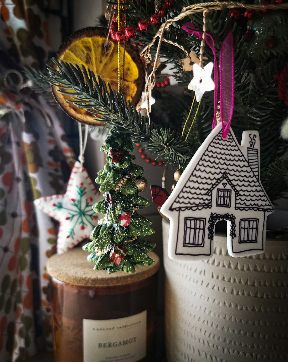 a small christmas tree with a white house and a white house