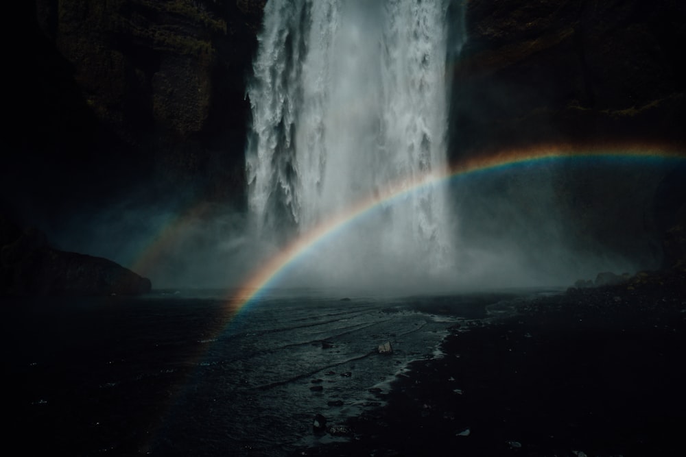 a waterfall with a rainbow