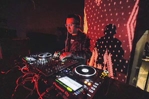 A DJ mixing live on a futuristic sound console with neon lights and smoke effects