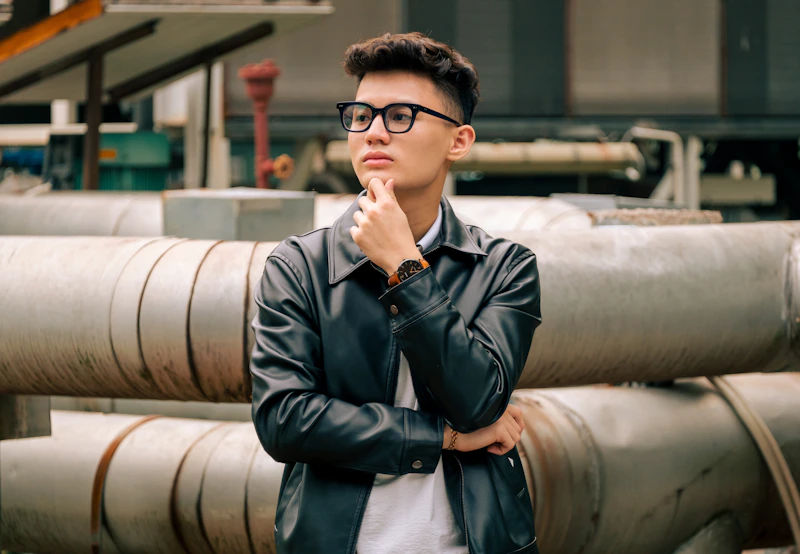 a man sitting on a metal pipe