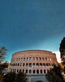 Traveler admiring the Colosseum in Rome during golden hour.
