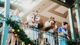 Mickey and Minnie mascots waving happily at a festive event