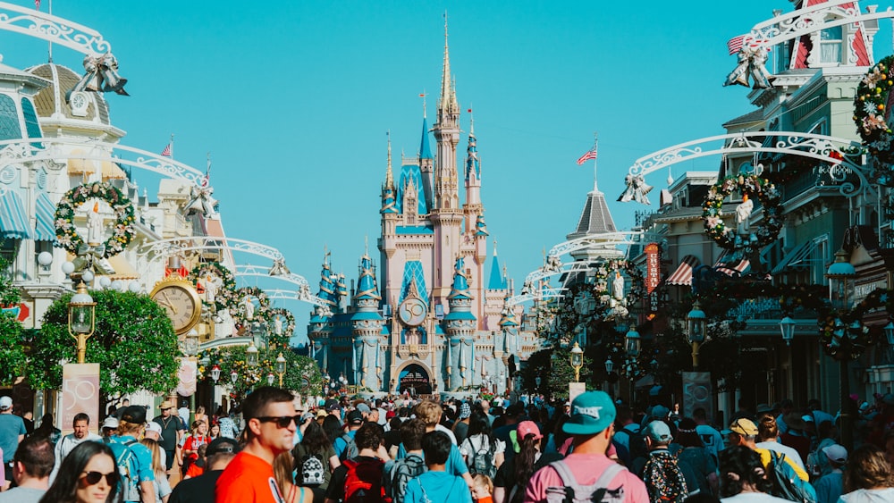 a crowd of people walking in front of a castle