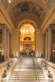 A spacious villa entrance with movers carrying furniture down the steps, demonstrating careful handling.